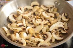 mushrooms are being cooked in a pan on top of the stovetop, ready to be eaten