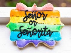 a decorated cookie with the words sorry or serenity on it and a rainbow flag