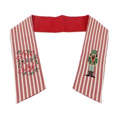 a red and white striped scarf with an image of a nutcracker on it