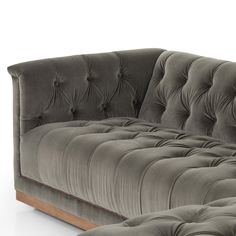 a gray couch and ottoman sitting next to each other