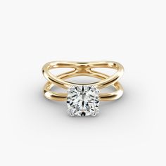 a yellow gold ring with a round cut diamond on the top and two bands around it