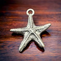 Sterling Starfish pendant/charm With this stunning, intricately designed product, you can enhance any charm bracelet or outfit and express your love for the ocean. Ocean-inspired Charms For Jewelry Making, Starfish Shaped Jewelry With Star Charm As Gift, Starfish Charm Pendant Necklace Gift, Starfish Charm Metal Necklace For Gift, Starfish Charm Pendant Necklace For Gift, Metal Necklace With Starfish Charm For Gift, Gift Starfish Charm Pendant Necklace, Beach Jewelry With Starfish Charm, Starfish Charm Necklace Perfect For Gifts