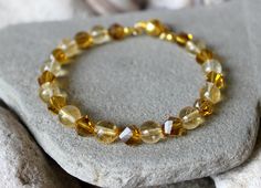 "8mm Citrine Bracelet, Woman Citrine Jewelry, Chakra Balancing Energy Bracelet, Gold Crystal Bracelet, Yellow Bead Bracelet, Gift for Her, Woman Birthstone Bracelet, Girlfriend Birthday Gift, November Gemstone Jewelry, Solar Plexus Chakra Bracelet Gorgeous bangle bracelet made of 8 mm. Citrine beads and gold crystals. The beads are strung on hard memory wire. With gold plated magnetic  clasp. Ready to ship. Choose your wrist size with the option. 5.5\" - 14 cm. 6\" - 15.2 cm. 6.5\" - 16.5 cm. 7\ Spiritual Faceted Crystal Bangle Bracelet, Gold Hand-strung Crystal Bangle Bracelet, Gold Crystal Rondelle Bracelet With Faceted Beads, Gold Crystal Bracelet With Gemstone Beads For Healing, Gold Crystal Bangle Bracelet With Faceted Beads, Gold Faceted Crystal Bracelet Spiritual Style, Gold Faceted Crystal Bracelet For Spiritual Wear, Gold Crystal Bracelet With 8mm Beads, Gold Crystal Bangle Bracelet With Spacer Beads