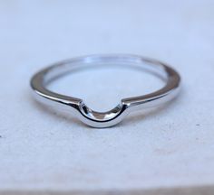 Here are our curved wedding bands This ring has been designed to curve around the setting of the below ring, this helps both rings to sit as flush as possible: https://www.etsy.com/uk/listing/279124136 Band width: 1.75mm Band height: 1.6mm Gap inside curved part of ring is 5mm wide by 2.5mm deep. We produce this ring in two metals for you to choose from: Sterling silver: This is a very popular material, known for its great durability. Silver pieces are known to require no maintenance and will la Curved Wedding Rings With Polished Finish, Minimalist Curved Wedding Jewelry, Minimalist Curved Wedding Rings, Modern Curved Wedding Rings, Modern Curved Jewelry For Wedding, Modern Curved Wedding Jewelry, Curved Jewelry With Polished Finish For Anniversary, Band For Oval Ring, Wedding Band For Oval Ring