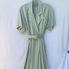 Classy, Cool And Confident; This Dress Says It All In Just The Right Of Tone. Heads Will Turn And The Room Will Take Notice As You Saunter In To The Room In This Subtle Mint Green Belted Swing Skirt Classic. 100% Rayon The Weight Is Perfect, Drapes Elegantly And Feels Fabulous. Petite Size 5/6. Never Worn And Ready For The Right Woman. You've Heard The Saying, "Feels Like A Million Bucks?!" You Will Feel Like A Million Bucks, Look Like You Spent As Much And Definitely Like You're Worth It. Classic Green Spring Dress, Vintage V-neck Midi Dress For Work, Vintage Belted Dresses For Work, Summer Vintage Midi Dress For Workwear, Classic Green Spring Midi Dress, Classic Green Midi Dress For Spring, Vintage V-neck Dress For Workwear, Vintage Belted Workwear Dresses, Vintage Midi-length Belted Dress