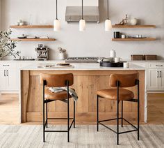 two brown chairs sitting on top of a kitchen counter