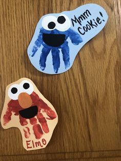 two handprinted puppets are sitting on a table with the words elm and cookie