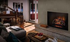 a living room filled with furniture and a fire place next to a sliding glass door