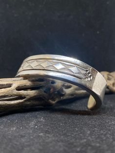 Spectacular Handmade Native American Navajo plain sterling silver cuff Bracelet by artist Bruce Morgan. Stamped sterling & by artist Bruce Morgan. Conditions are new with tags. This gorgeous bracelet is made with the famous Navajo style. The bracelet is extremely detailed. Inside of bracelet also has gorgeous stamping. Very Heavy. Stamped inside From one end to the other the bracelet is approximately 6 inch's The opening of the bracelet is approximately 1 1/2 inch's. The width of the bracket is Silver Hand Stamped Bangle Jewelry, Hand Stamped Silver Bangle, Bohemian Silver Hand Stamped Bracelets, Silver Hand Stamped Bangle, Vintage Silver Bracelets Hand Stamped, Bohemian Cuff Bracelet With Polished Finish, Sterling Silver Cuff Bracelet Hand Stamped, Hand Stamped Sterling Silver Cuff Bracelet, Artisan Engraved Bangle Jewelry