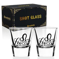 two shot glasses sitting next to each other in front of a box with the word shot glass on it