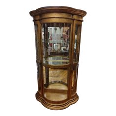 a wooden corner cabinet with glass doors