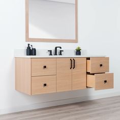 a bathroom vanity with two drawers and a mirror