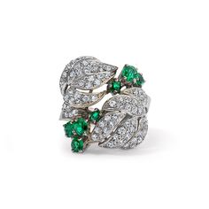 Fall in love with this one-of-a-kind vintage white gold Diamond and Emerald Floral Motif ring. With seven emeralds and forty-six diamonds, it's a classic piece radiating both elegance and charm. Available in 18K White Gold Available in a size 7 Ring can be resized between sizes 6-8 for an additional fee. Please contact our team at info@stephaniegottlieb.com for more information. Green Emerald weight = 0.78 carats Diamond weight = 0.72 carats Diamond quality = FG color, VS clarity Origin = German Platinum Emerald Ring In White Gold, Fine Jewelry Platinum Emerald Cluster Ring, Fine Jewelry Platinum Cluster Emerald Ring, Fine Jewelry Emerald Ring With Cluster Shape In Platinum, Luxury Multi-stone Emerald Ring With Diamonds, Luxury Multi-stone Emerald Platinum Ring, Luxury Cluster Emerald Ring With Diamonds, Green Emerald Cluster Ring In Platinum, Cluster Green Emerald Ring In Platinum