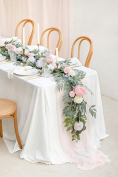 the table is set with flowers and candles for an elegant wedding reception at longs