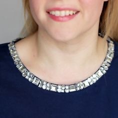 a woman is wearing a necklace made from silver beads and has the words simple diy jeweled collar refashion on it