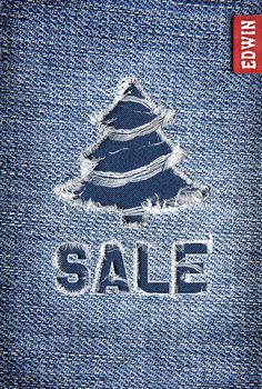 the sale sign is made out of blue jeans and has a christmas tree on it