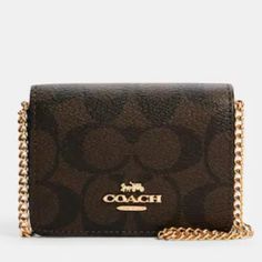 Coach - Signature Canvas Mini Wallet With Chain (Nwt) Color - Black And Brown Signature Coated Canvas And Smooth Leather Two Credit Card Slots Snap Closure Fabric Lining Outside Open Pocket Detachable Chain Strap Approximate Size - 4" (L) X 3" (H) X 1" (W) Smoke And Pet Free Home Coach Rectangular Wallet On Chain, Coach Wallets With Chain Strap For Everyday Use, Coach Rectangular Wallet On Chain With Strap, Coach Classic Rectangular Wallet On Chain, Coach Gold Wallet On Chain With Chain Strap, Classic Coach Wallet On Chain, Elegant Brown Wallet With Chain Strap, Elegant Brown Wallets With Chain Strap, Coach Brown Shoulder Bag With Chain Strap