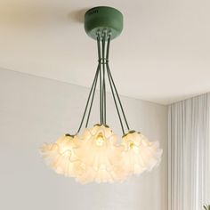 a green chandelier hanging over a dining room table