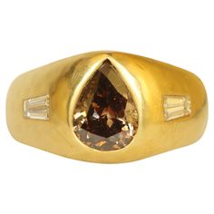 Handmade 22k yellow gold ring featuring a 1.50ct fancy coffee-colored pear-shaped center diamond (Calrity SI1) and 2 baguette-cut side diamonds (0.25cttw, Clarity VS1, Color G). Crafted by Bracken Jewelers in Venice, California. Locally made and one-of-a-kind. Visit us on our website for more product information and additional photos. 22k Gold Ring, Venice California, Ceylon Blue Sapphire, Split Shank Ring, 3 Stone Rings, Fancy Coffee, Color Cafe, Modern Ring, Stone Engagement Rings