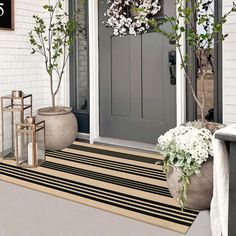 the front door is decorated with flowers and potted plants