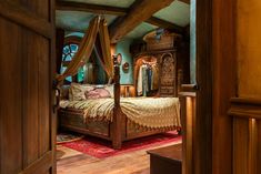 a bed sitting in the middle of a bedroom next to a wooden dresser and mirror