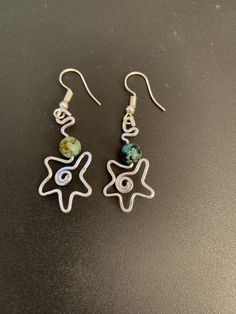 the earrings are made with wire and beads, which have been handcrafted to look like stars