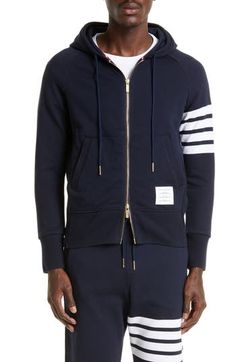 Engineered stripes at the left sleeve play up the sporty look of a cotton French terry hoodie featuring ribbed side panels for enhanced comfort and mobility. Tricolor aglets and a name tag at the hem are customary Thom Browne touches. 26" length (size 2) Drawstring hood Two-way front-zip closure Split kangaroo pocket Ribbed cuffs and hem 100% cotton Dry clean or hand wash, dry flat Made in Japan Collegiate Cotton Hoodie With Kangaroo Pocket, Team-colored Cotton Hoodie With Drawstring, Long Sleeve French Terry Hoodie With Double-lined Hood, Thom Browne Hoodie, Nylon Long Sleeve Hoodie With Double-lined Hood, Sides For Ribs, French Terry Hoodie, Cotton Hoodie, Sporty Look