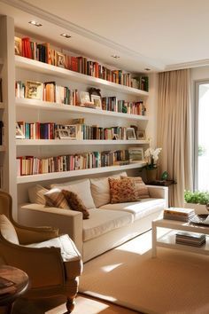 a living room filled with lots of furniture and bookshelves next to a window