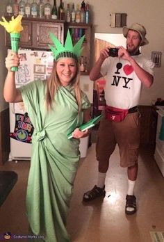 a man and woman dressed up as the statue of liberty