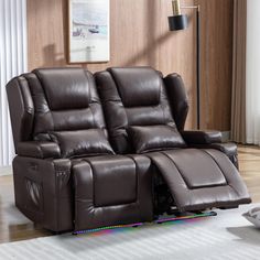 the reclining loveseat has two seats and is in front of a window