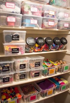 the shelves are filled with plastic bins and containers full of crafting supplies for kids