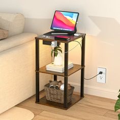 a laptop computer sitting on top of a wooden shelf