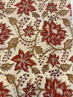 a red and white floral design on fabric