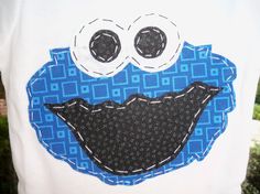 a close up of a person wearing a white shirt with a blue and black design on it