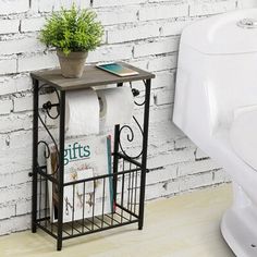 a shelf with books and magazines on it in front of a white brick wall next to a toilet