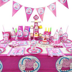 a peppa pig birthday party set up with pink and blue decorations, including cake