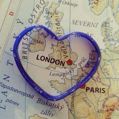 a blue heart shaped pin sitting on top of a map with the word london in it