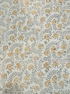 a white and yellow floral pattern on fabric