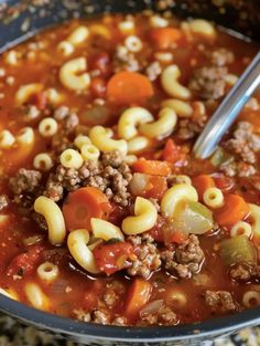 a bowl filled with pasta and meat soup