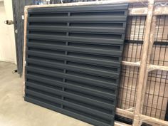 several cages are stacked on top of each other in a storage area at a warehouse