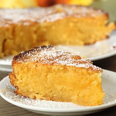 a piece of cake sitting on top of a white plate next to an apple pie