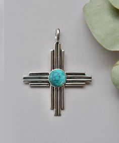 Turquoise Zia Pendant / Handmade Zia Symbol Pendant / Zia Statement Jewelry / New Mexico Zia Necklace / Zia Sun Pendant For Native Americans items : Pendant & Necklace Stone : Turquoise Shape : Zia Symbol Cut : cabochon  Material : 925 Sterling Silver Measurement : 2''x 2'' (inch) Zia Symbol : The Zia symbol consists of a circle with four groups of rays radiating from the center, forming a sun-like image. Each group typically has four rays, representing various aspects of life, such as the four Bohemian Blue Cross Jewelry, Bohemian Turquoise Cross Jewelry, Blue Bohemian Necklace With Cross Pendant, Bohemian Blue Cross Pendant Necklace, Bohemian Turquoise Cross Necklace, Bohemian Turquoise Cross Pendant Jewelry, Handmade Turquoise Cross Jewelry, Bohemian Turquoise Cross Pendant Necklace, Handmade Turquoise Cross Pendant Necklace