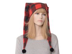 Below the shoulder red black buffalo plaid two pointed stocking hat.  The two points on this hat face to the rear.  Each of the tips is trimmed with black pompoms. Double thick headband. One size fits most for heads measuring 22-24 inches. Thick Headband, Sleep Hat, Thick Headbands, Jester Hat, Gnome Hat, Stocking Hat, Stocking Cap, Warm Winter Hats, Fantasy Costumes