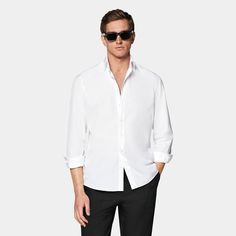 Discover effortless elegance with this crisp white shirt, boasting a flattering tailored silhouette and meticulous details like heat-sealed buttons and an offset armhole seam for a sharp look. Modern Semi-formal Spring Dress Shirt, Slim Fit Summer Dress Shirt For Business, Slim Fit Summer Business Dress Shirt, Summer Slim Fit Dress Shirt For Business, Summer Business Slim Fit Dress Shirt, Sleek White Summer Tops, White Collared Business Shirt, Sleek Formal Spring Shirt, Timeless Summer Shirt With Spread Collar