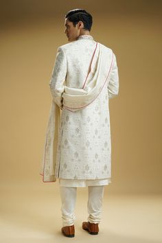 Off-white silk dupion sherwani with floral jaali embroidery. Comes with a cotton silk kurta, churidar, and a stole.
Component: 4
Pattern: Embroidered
Type Of Work: Floral jaali
Neckline: Mandarin collar
Sleeve Type: Full
Fabric: Silk dupion, Kurta : Cotton silk
Color: Off White
Other Details: 
Embellished buttons on front placket
Embroidered borders on stole
Occasion: Groom, Wedding - Aza Fashions Silk Sherwani With Straight Kurta For Wedding, Silk Straight Kurta Sherwani For Wedding, Designer Cotton Silk Sherwani With Traditional Drape, Festive Cotton Silk Sherwani With Naqshi Detailing, Cotton Silk Sherwani With Dupatta, Ceremonial Silk Sherwani With Dupatta, Silk Sherwani With Dupatta For Ceremonial Occasions, Ceremonial White Dupatta With Naqshi Detail, White Naqshi Dupatta For Ceremonial Occasions