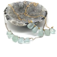 "Raw Crystal Gold  Necklace, Natural Aquamarine Necklace, Bridal Gift, March Birthstone, Natural Gemstone  A beautiful and elegant Natural Aquamarine Necklace. These necklace is perfect for layering,  and are simple enough for every day wear.  Available in gold and silver.  M A T E R I A L S ∙ A N D ∙ S I Z E  * MATERIAL Components: Chain is 14k gold filled Stones: Aquamarine   Findings: 18k gold filled  * SIZE:  Length: ~16-18inch - Nickel Free *Please note: Because we use natural stones, the stones may vary slightly in shape, shade and size. They may also contain natural inclusions.  C U R R E N T ∙ P R O D U C T I O N ∙ T I M E S All items are made to order, so please check the top of our policies page for the most up to date production and delivery times.  E X P E D I T E D ∙ S H I P P Fusion Style Emerald Necklace For Gift, Fusion Style Emerald Necklace Gift, Fusion Style Emerald Gemstone Necklace Gift, Briolette Necklace With Natural Stones For Anniversary, Anniversary Briolette Necklace With Natural Stones, Fusion Style Faceted Necklace For Gift, Aquamarine Necklace, Necklace Bridal, March Birthstone