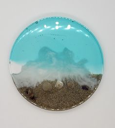 Enjoy a touch of the seaside with these Sea scape coasters with holder. Combining real sand and shells with epoxy resin, each coaster set of 4 is handmade to order and makes a perfect personalized gift for beach lovers. Unique and distinctive, these coasters provide a special keepsake to commemorate family vacations, special occasions, and more. Bring the beauty of the ocean into your home with our Sea Scape Coasters with Holder. The resin coasters and holder feature realistic details of the sea Ocean Coasters, Beach Coasters, Sea Scape, Coasters With Holder, Resin Coasters, Safe Storage, Family Vacations, The Seaside, Beach Lovers