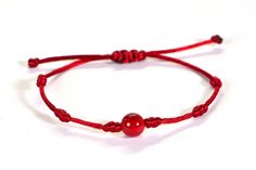 A knitted cord bracelet with a beautiful natural red coral  Knotted silky nylon cord Adjustable to any size. The cord is 1.5mm thick and the natural coral is 8mm. Wear it alone or layer it with your other favorite bracelets.    The bracelet is made with adjustable sliding knots - you will get a perfect fit with this bracelet.  Gently slide the knots away from the beads to open the bracelet.  Slip it over your hand to your wrist, then slide the knots back to the beads for a comfortable fit.  When in doubt, order a smaller size (smaller can be adjusted bigger. Bigger sizes can not be adjusted smaller). Knitted Cord, String Of Fate, Bracelet String, Red String Bracelet, Bracelet Love, Hippie Bracelets, Coral Bracelet, Single Bead, Red String