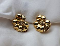 Lovely vintage earrings in gold tone metal, clip-on, floral design with small crystals in centre. Measures approximately 3 cm/1.2 in diameter. Excellent vintage condition Vintage Gold Flower-shaped Earrings, Vintage Gold Flower Shaped Earrings, Yellow Gold Clip-on Earrings With Flower Shape, Vintage Gold Flower Clip-on Earrings, Brown Logo Design, Green Cocktail Dress, Small Crystals, Browning Logo, Rattan Bag