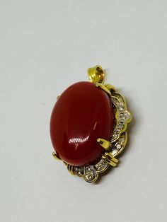 "This is a 14K yellow gold, large oval matte red cabochon + diamond pendant/charm. Material(s): 14K yellow gold + (1) large oval cabochon matte red + diamonds Weight: 11.6 grams Flaws (if any): None to mention Marking(s): \"585\" (translating to \"14K\") Measurements: This pendant/charm measures 34.6 millimeters in height and 23.7 millimeters in width. This pendant/charm measures 13.5 in thickness. See photo with quarter for size comparison. If you have any questions about this pendant/charm, pl Vintage Yellow Gold Cabochons As Gift, Vintage Yellow Gold Cabochons For Gift, Elegant Gold Oval Cabochons, Elegant Yellow Gold Oval Cabochons, Exquisite Gold Oval Cabochon Jewelry, Luxury Red Oval Cabochon Jewelry, Luxury Gold Cabochons For Gift, Exquisite Red Cabochon Jewelry, Antique Red Oval Pendant Jewelry